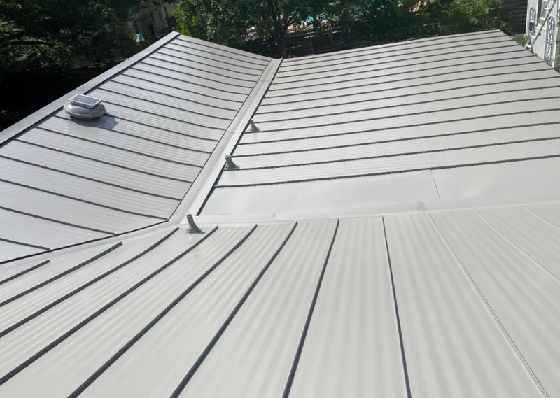 Solar attic fan installed on a metal roof for Roof Ventilation in Kalkaska